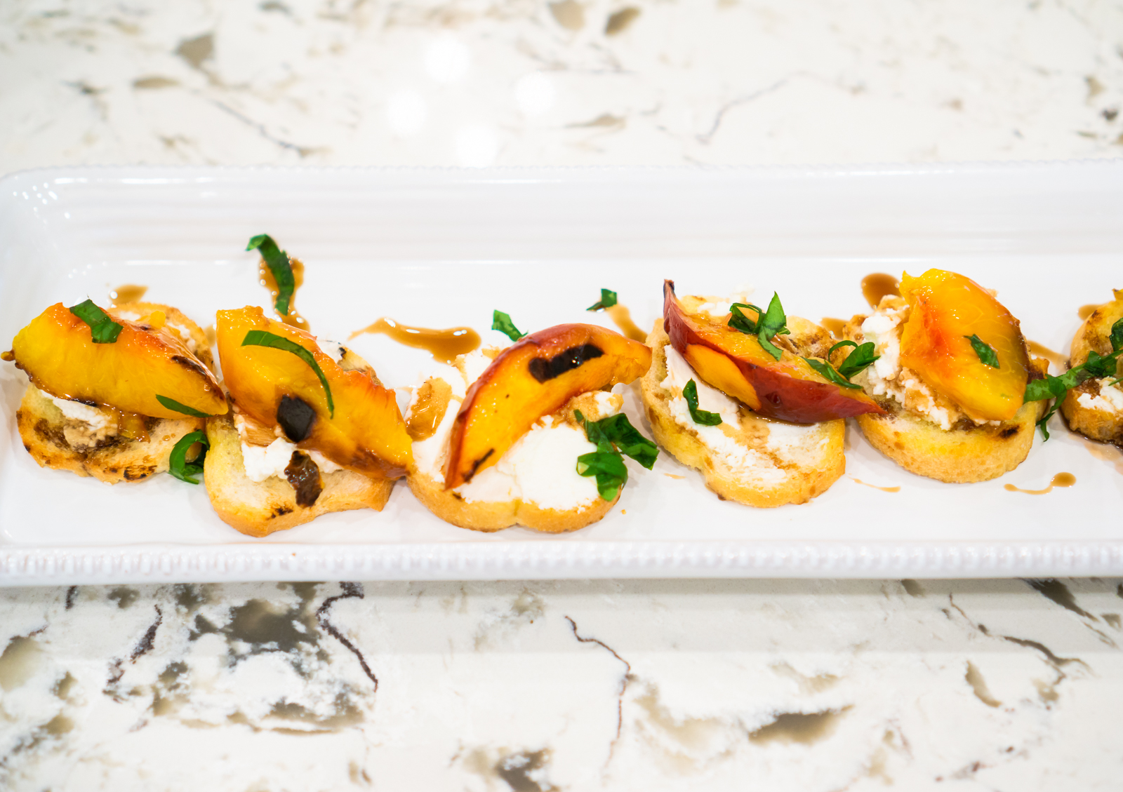 GRILLED NECTARINE CROSTINIS WITH GOAT CHEESE AND BASIL