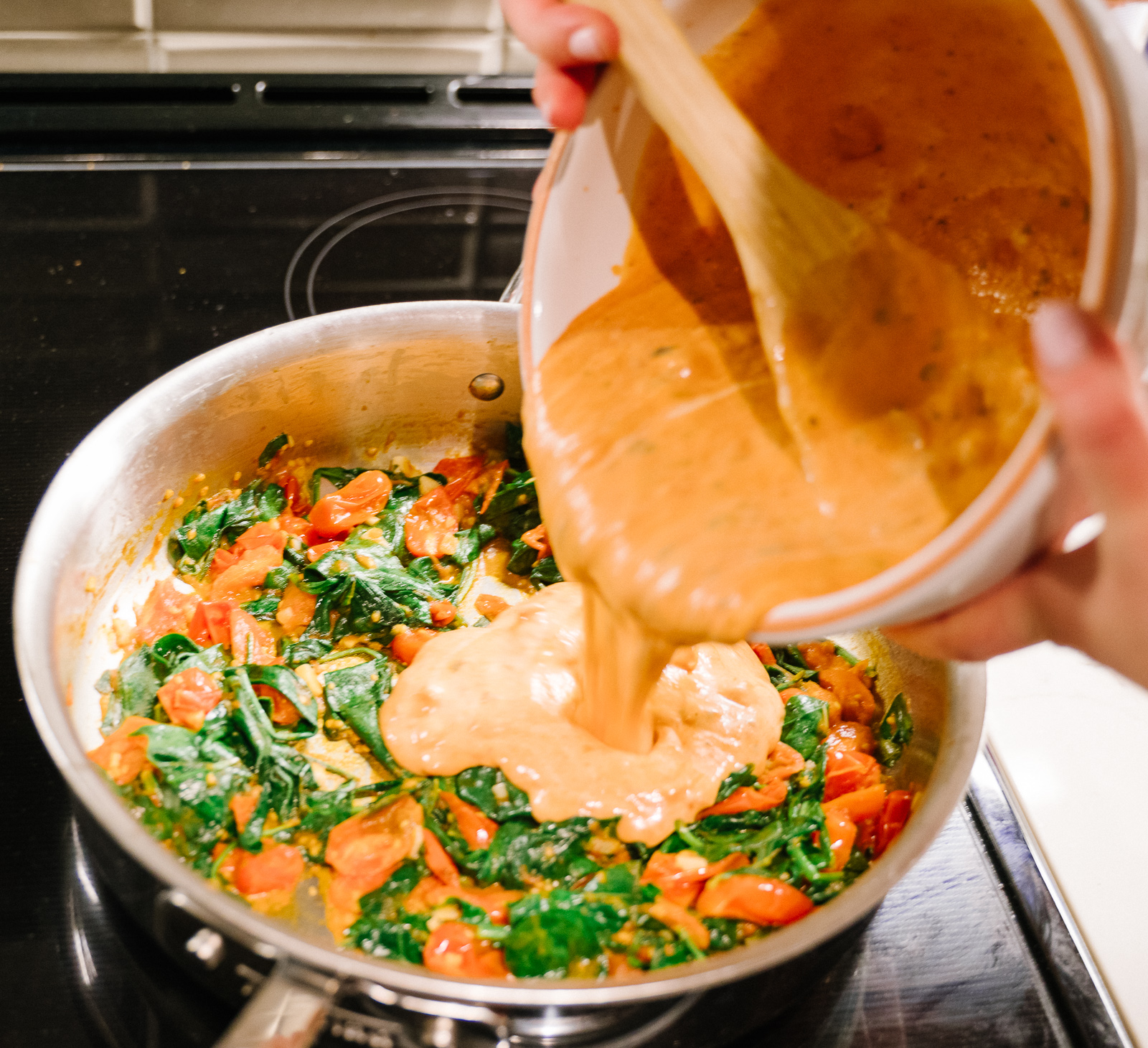mixing the Bertolli Alfredo sauce on veggies for one of the best Rosa Sauce Recipe